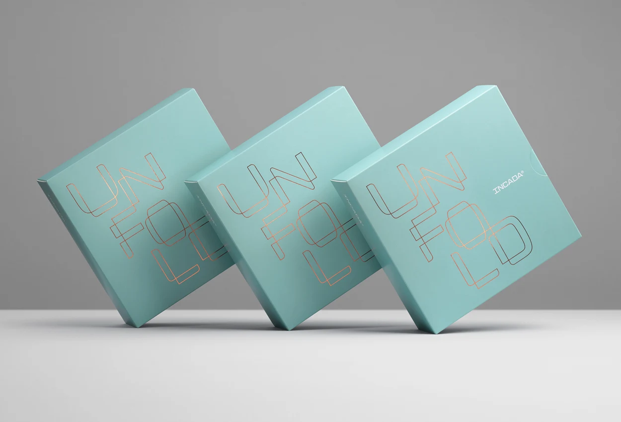 Three blue paperboard boxes placed against a grey background