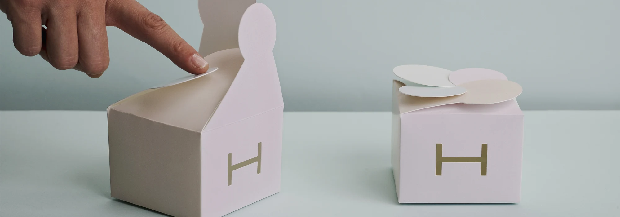 Baby pink packages on light blue background