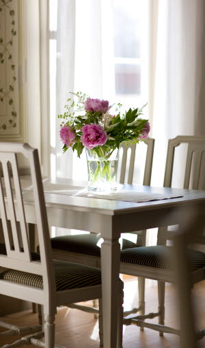 Close-up of dining table with bouquet of flowers