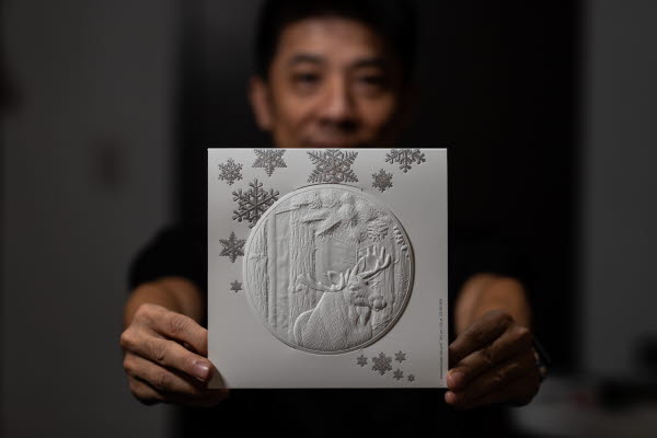 Kevin Chen holding up the finished greeting card