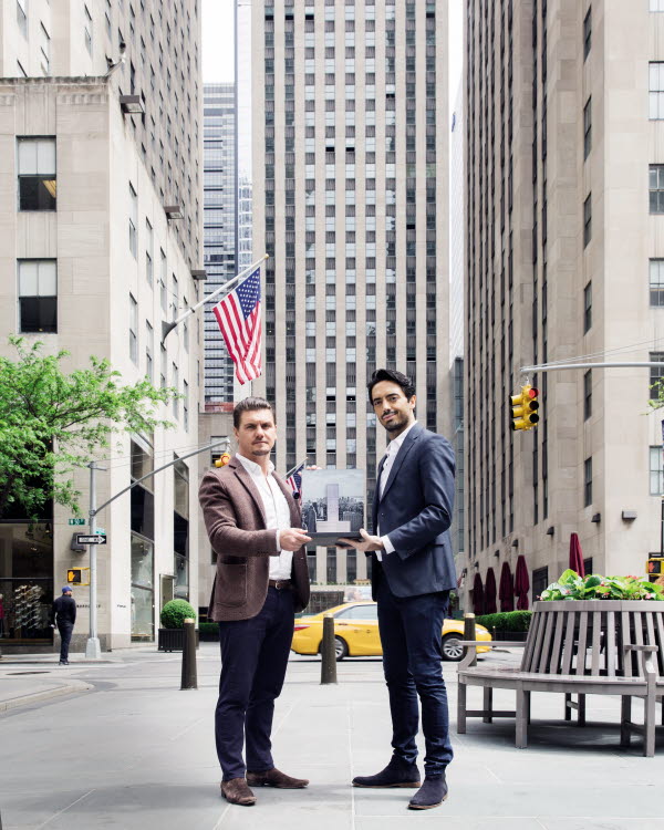 Mark J. Williams and colleague holding 3D pop-up book in New York street