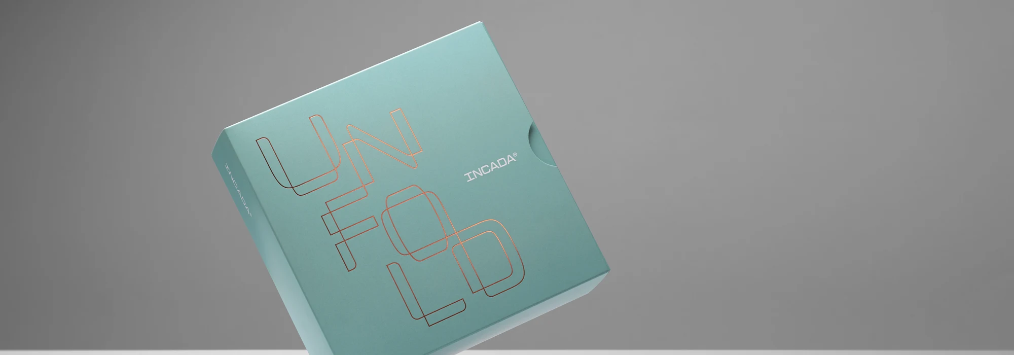 Blue paperboard box flowing against grey background