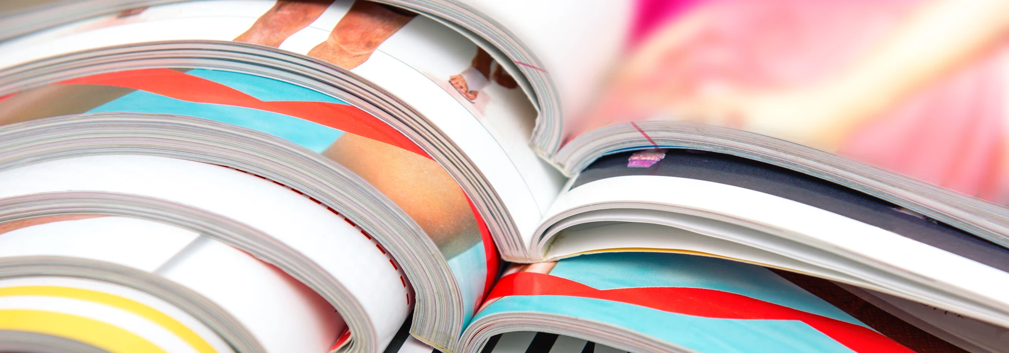 Open books or catalogues in a pile