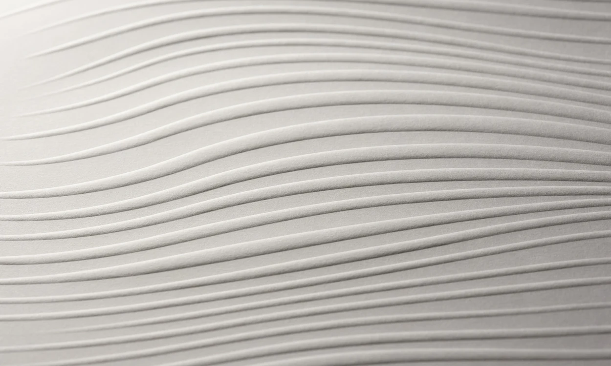Paperboard embossed in the shape of waves