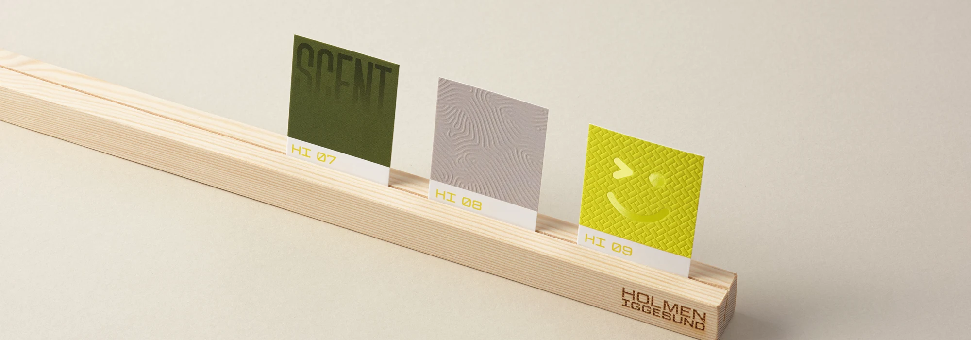 Colourful paperboard sample cards in a holder on a grey background