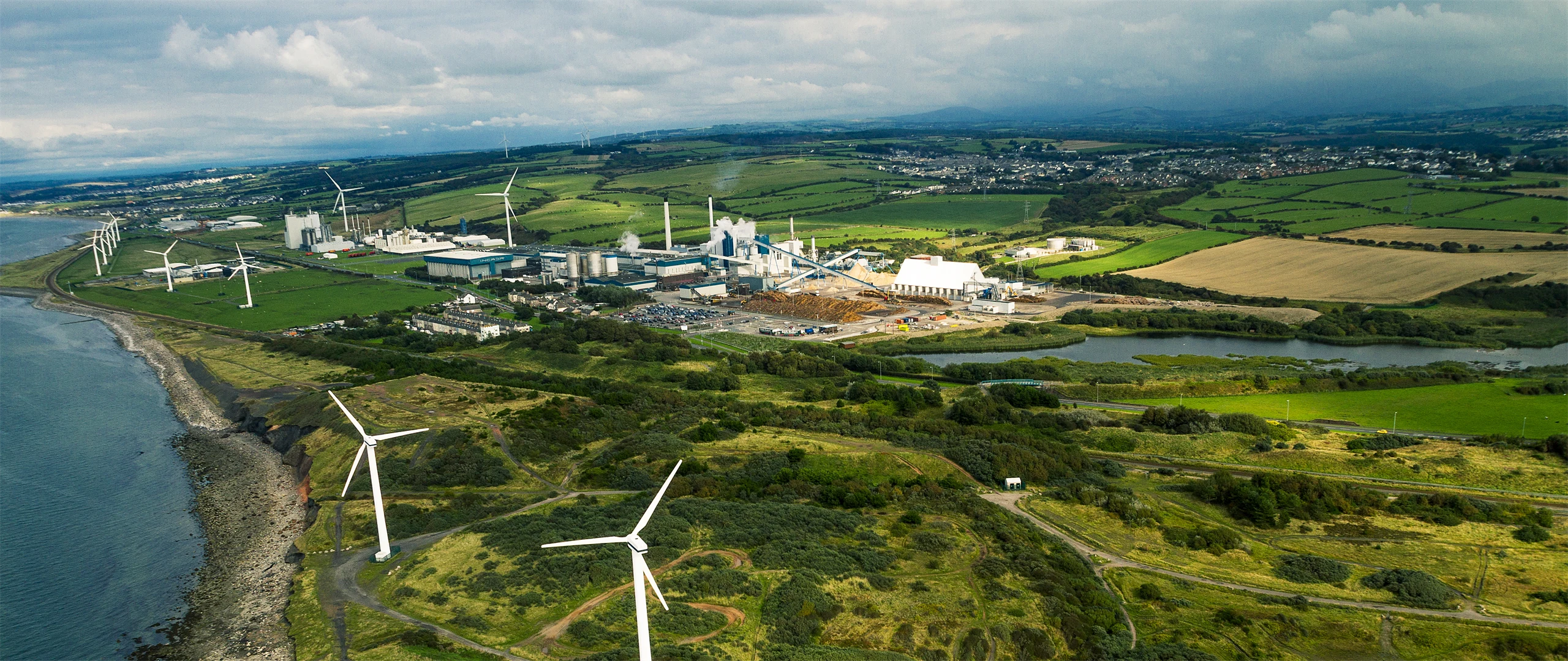 Picture of woman in front a paperboard machine in Workington mill