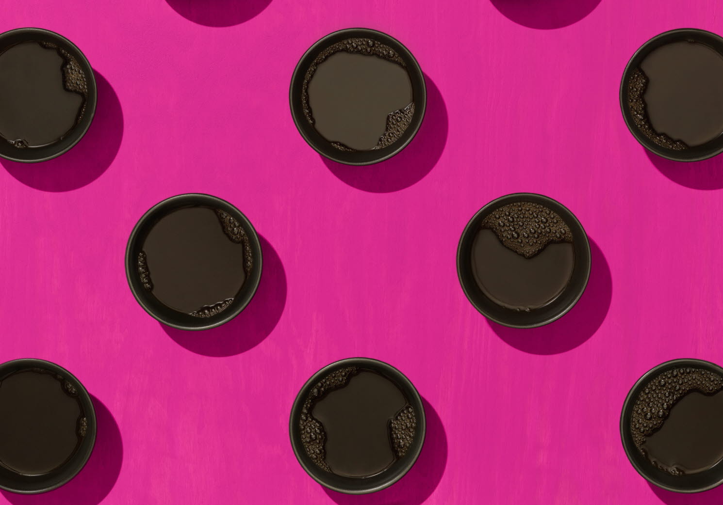 Coffee cups against crimson background