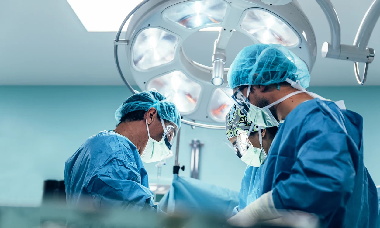 Surgeons operating with new medical technology