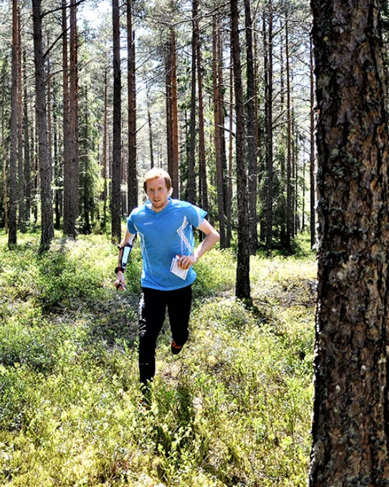 Orienteer running in forest