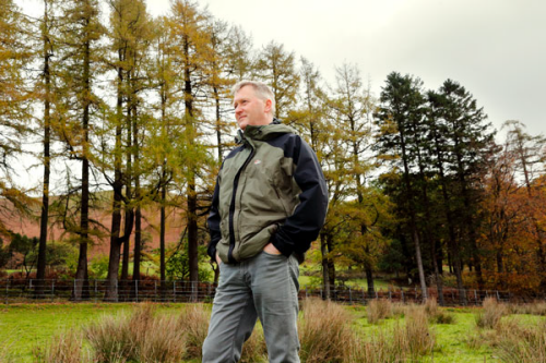 Ian Black standing in a green field