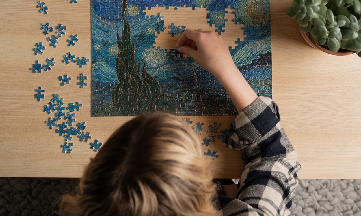 Kid Doing A Puzzle Made Of Invercote Duo Paperboard