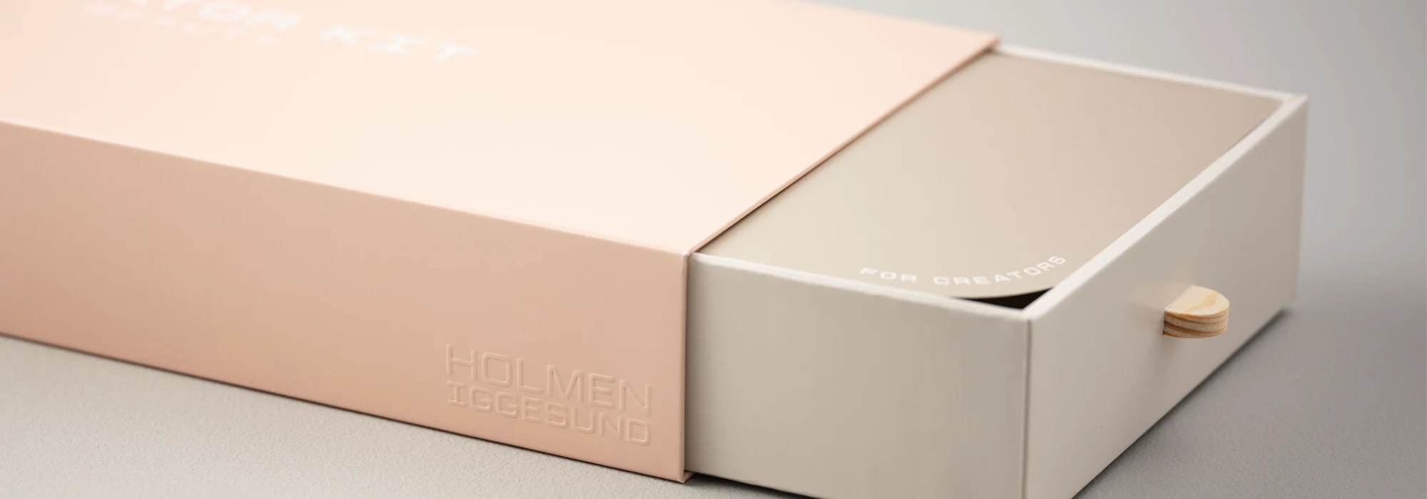 Peach coloured outer paperboard sleeve and insert tray
