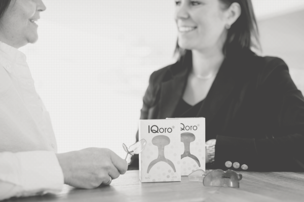 IQoro product and packaging on table with Ylvali Gerling and Agneta Wallner in black and white